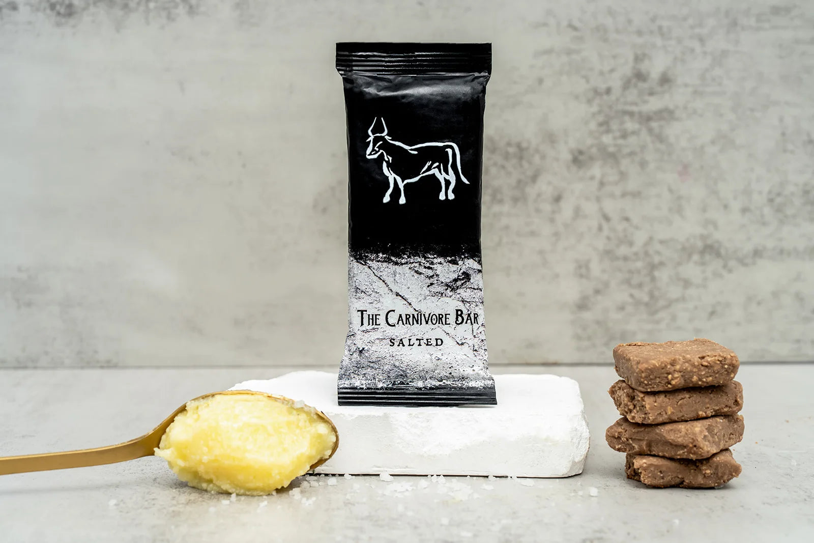 Everyday Carnivore Bars beside a campfire mug